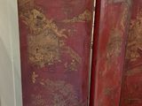 a red room divider with gold designs on it