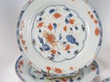 several pieces of blue and white plates with orange flowers on them