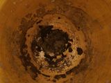 a close up of a brown bowl with dirt on it