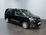 the black van is parked in a room with a white wall