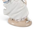 a figurine of a woman in a white dress