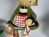 a small figurine of a little girl sitting on a bench