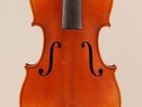 an old violin with a bow hanging from it ' s back