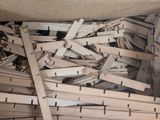 a box full of wooden clothes pegs and a pair of scissors