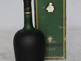 a bottle of liquor sitting next to a box on a table