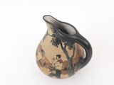 a black and white vase with a painting on it