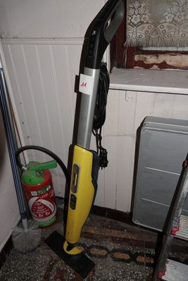 a vacuum that is sitting on the floor next to a window