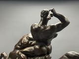 a bronze statue of a man riding a horse