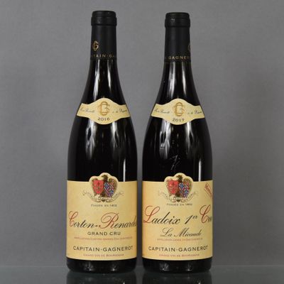 two bottles of wine sitting on top of a table next to each other