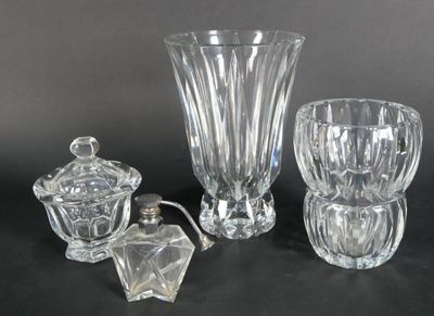 three glass vases and a candle holder sitting on a table