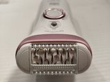 an image of a pink electric shaver on a table
