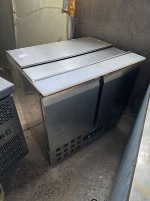 two microwaves that are sitting in the corner of a room