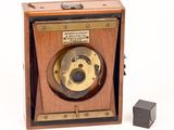 a small wooden box with a camera on top of it