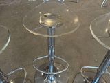 three clear stools sitting on top of a floor next to each other
