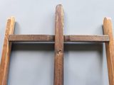 two wooden ladders are leaning against a wall on a gray background