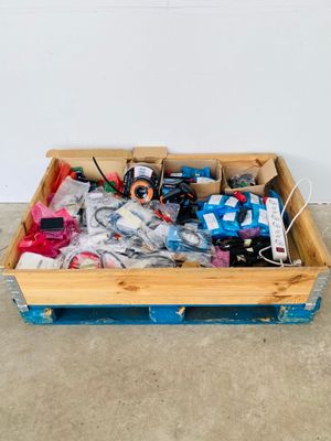 a wooden box filled with assorted items on the floor