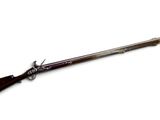 a rifle with a wooden barrel and a wooden handle