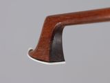 a close up of a violin bow on a gray background