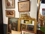 Il y a de nombreux tableaux encadrés accrochés au mur dans cette pièce.