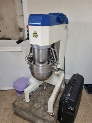 an image of a mixer and a suitcase in a room