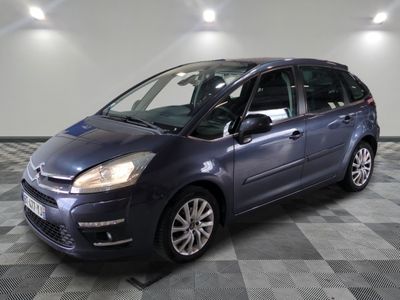 a picture of a small blue car parked in a garage