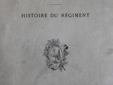 an old book with a picture of a coat of arms on it