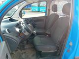 a blue car with black seats in a parking lot