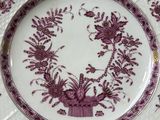 a purple and white plate with a flower design on it