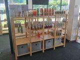 a room with a shelf full of bottles and glasses