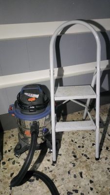 a vacuum and a chair in the corner of a room