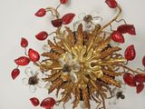 a gold and red chandelier hanging from the ceiling