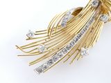 an image of a gold and diamond broochle on a white background