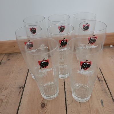 four glasses with a ladybug on them sitting on a wooden floor