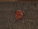 a piece of wood that has a red flower on it