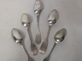 four spoons and a spoon rest on a white surface