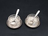 pair of silver plated salt and pepper shakers with spoons