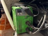 a green machine sitting on top of a counter next to an orange