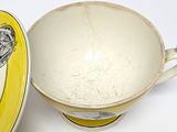 a yellow and white bowl and a yellow and white cup