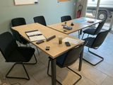 a table that has a lot of chairs around it