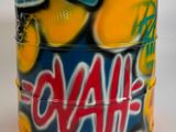 une canette recouverte de graffitis, posée sur une surface blanche