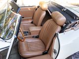 a white car with brown leather seats in the back of it