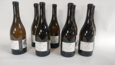 six bottles of wine are lined up in a row on a white surface
