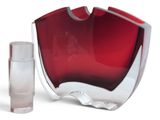 a red glass vase and a small clear glass container