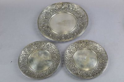 three silver plated dishes sitting on a white surface