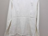 a white shirt hanging on a hanger on a wall