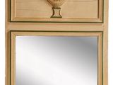 a mirror on the wall above a mirror with a vase on it