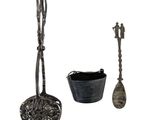 three pieces of silverware including a spoon, spoon and spoon rest