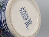 a blue and white vase with a castle on it