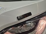a close up of a car ' s headlight with a sticker on it
