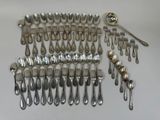 many spoons and spoons laid out on the table